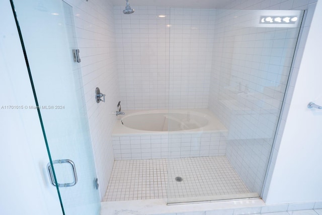 888 Biscayne Blvd Unit 3806, Miami, FL 33132 - full bathroom featuring a stall shower, tiled tub, and tile patterned flooring