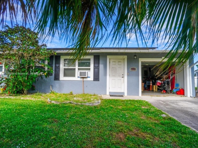 view of front of house with a front yard and a garage