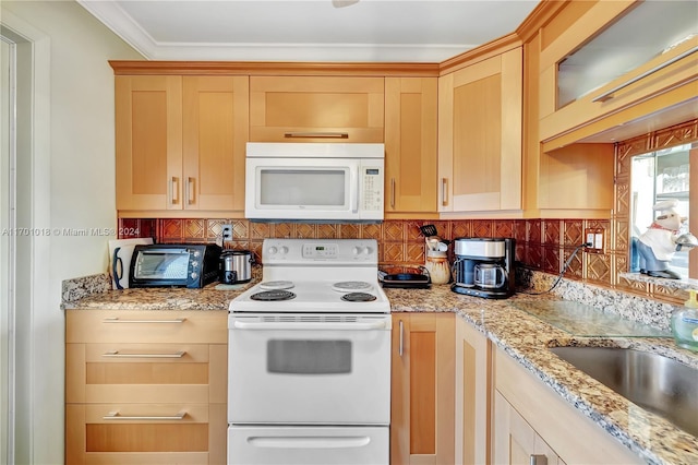 kitchen featuring backsplash, light brown cabinets, and white appliances