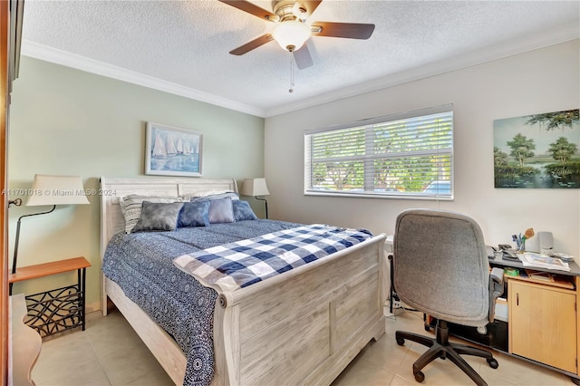 tiled bedroom with a textured ceiling, ceiling fan, and crown molding