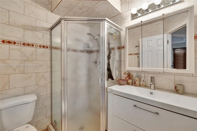 bathroom with backsplash, an enclosed shower, vanity, tile walls, and toilet