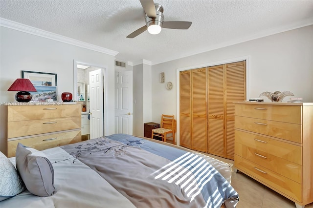 tiled bedroom with a textured ceiling, a closet, ceiling fan, and crown molding