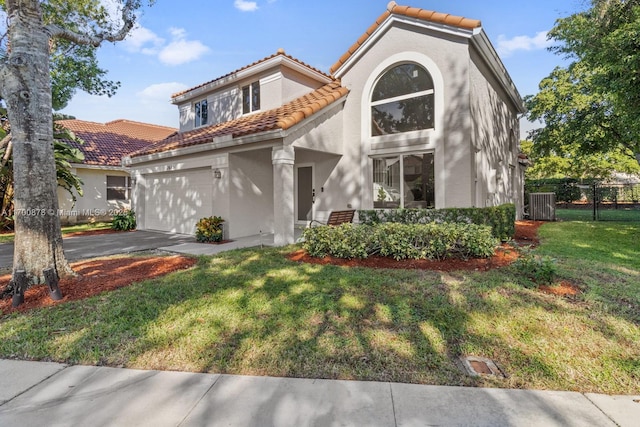 mediterranean / spanish-style house with a garage and a front lawn