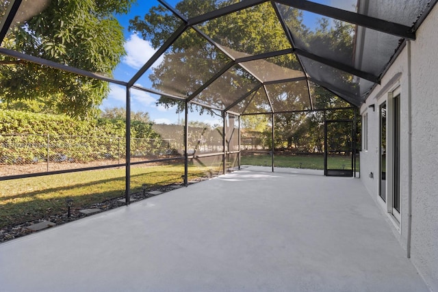 view of patio with glass enclosure