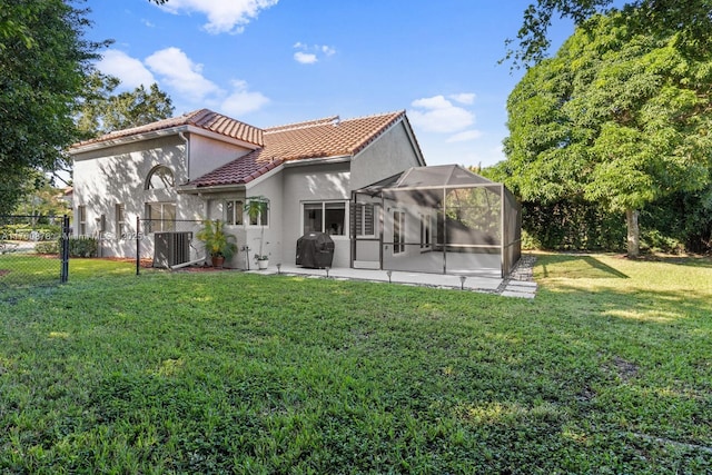 back of house with a patio, glass enclosure, cooling unit, and a lawn