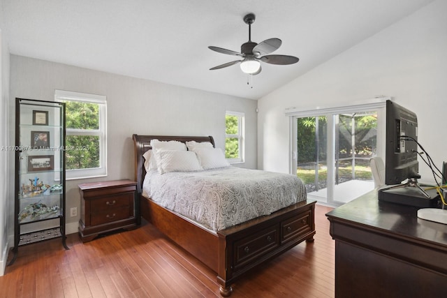 bedroom with multiple windows, access to exterior, dark wood-type flooring, and lofted ceiling