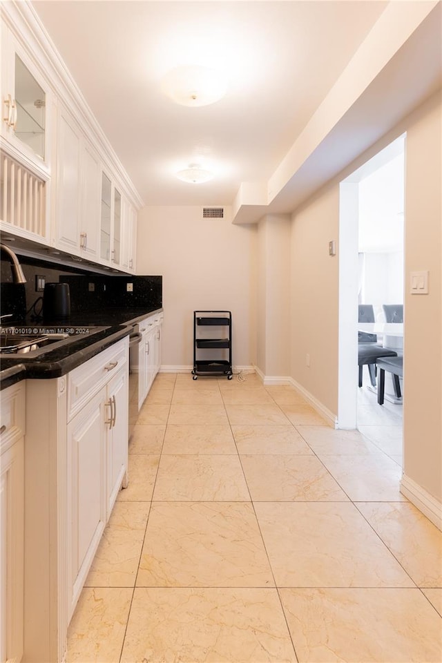 kitchen with white cabinets, dishwasher, and sink