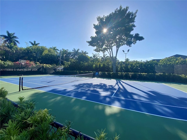 view of tennis court featuring fence