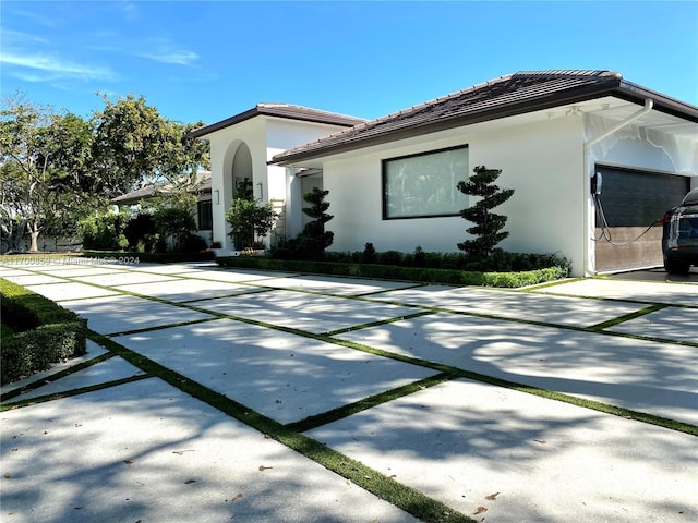 view of home's exterior featuring a tiled roof and stucco siding