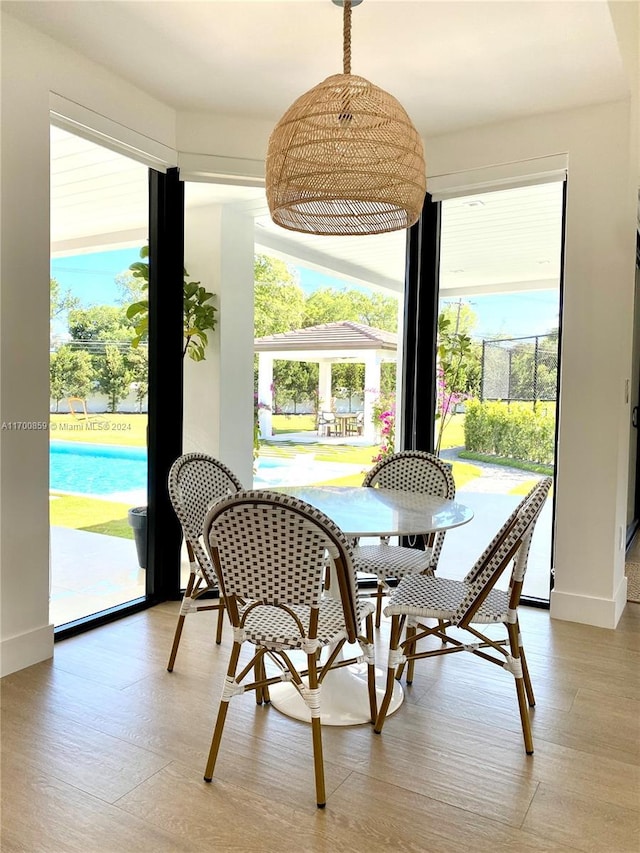 dining space featuring a healthy amount of sunlight, baseboards, and wood finished floors