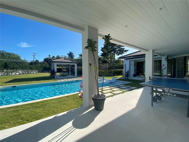 pool featuring a lawn, a patio, and a gazebo