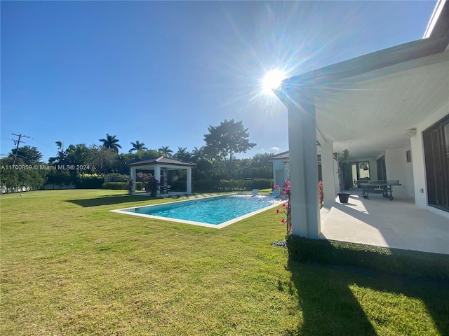 outdoor pool with a gazebo, a yard, and a patio area