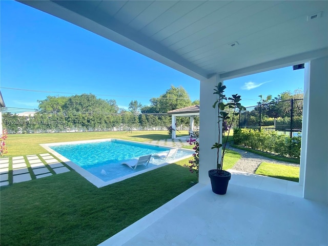 pool with a patio area, a lawn, a gazebo, and fence