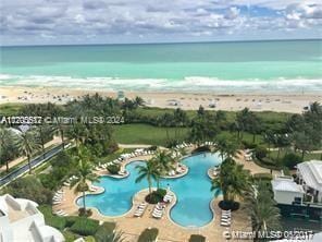 view of swimming pool featuring a water view