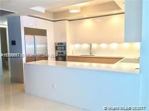 kitchen with white cabinetry, sink, and appliances with stainless steel finishes