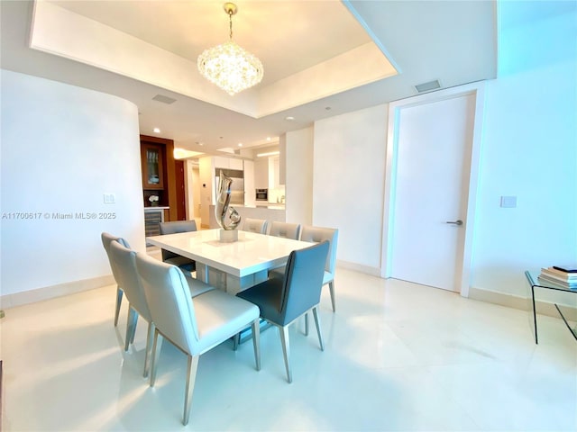 100 S Pointe Dr Unit 1207, Miami Beach, FL 33139 - dining area with a chandelier, recessed lighting, a tray ceiling, and baseboards