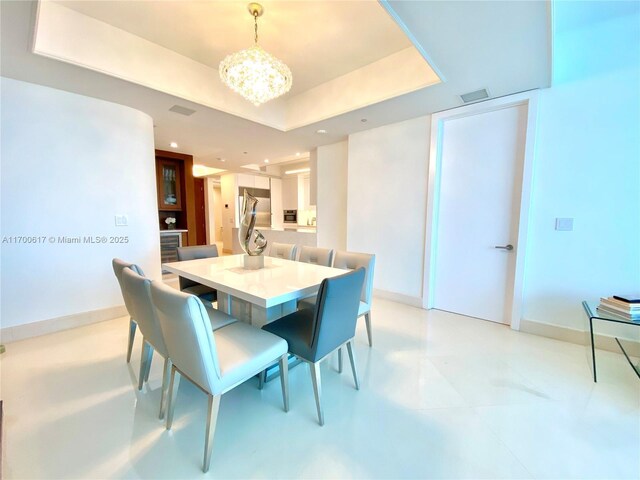 100 S Pointe Dr Unit 1207, Miami Beach, FL 33139 - dining space featuring a chandelier, recessed lighting, and a raised ceiling