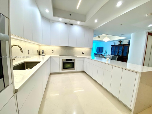 100 S Pointe Dr Unit 1207, Miami Beach, FL 33139 - kitchen featuring stainless steel oven, a sink, modern cabinets, a peninsula, and recessed lighting