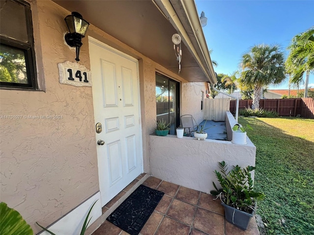 property entrance with a yard