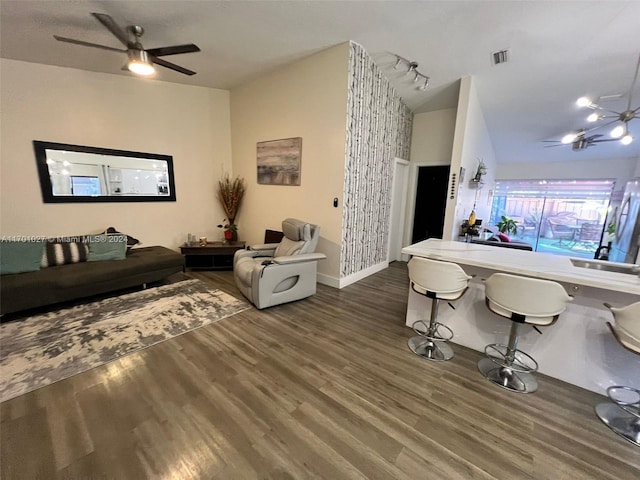 living room with ceiling fan and dark hardwood / wood-style flooring