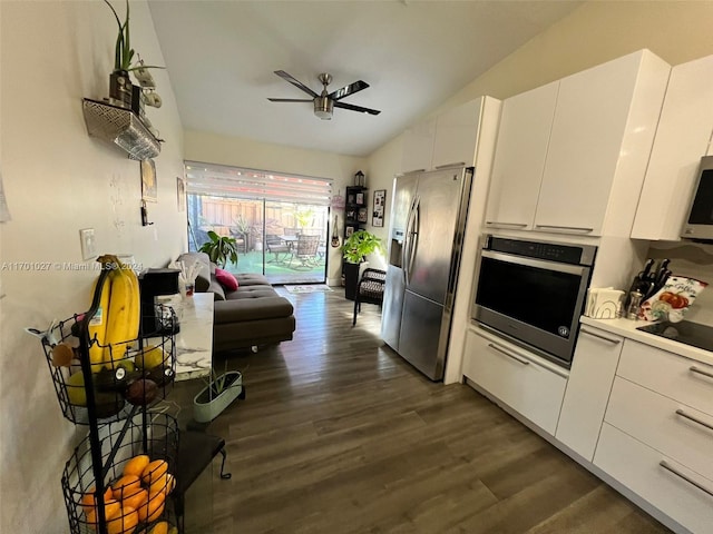 kitchen with appliances with stainless steel finishes, dark hardwood / wood-style flooring, vaulted ceiling, ceiling fan, and white cabinets