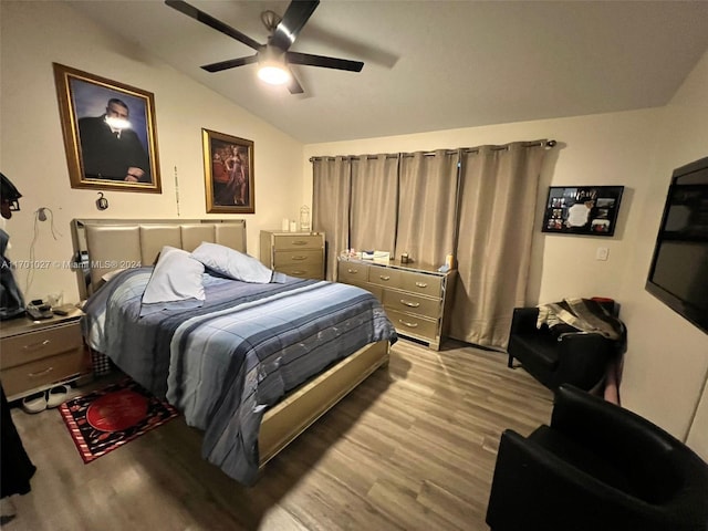 bedroom with ceiling fan, lofted ceiling, and light hardwood / wood-style flooring