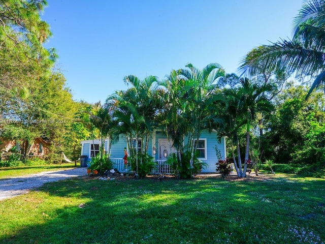 obstructed view of property featuring a front yard