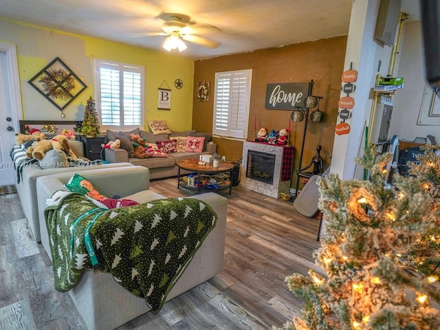 living room with hardwood / wood-style flooring and ceiling fan