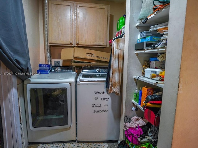 laundry room with cabinets and washing machine and dryer