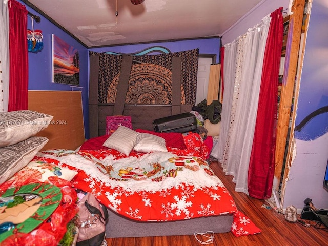 bedroom with hardwood / wood-style flooring and crown molding