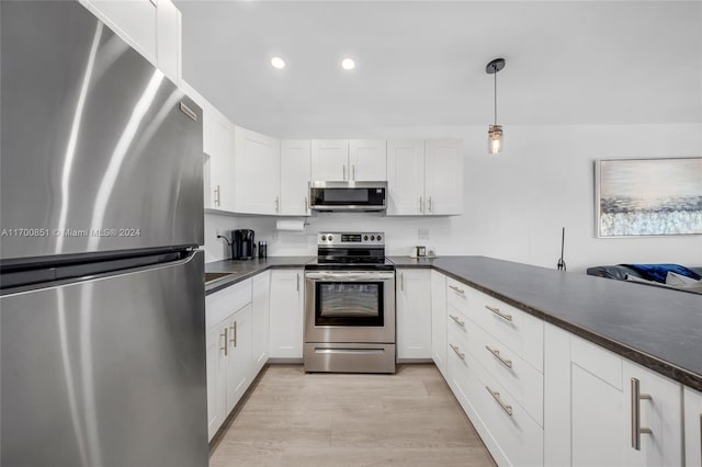 15610 NE 6th Ave Unit 33D, Miami, FL 33162 - kitchen with appliances with stainless steel finishes, dark countertops, white cabinetry, recessed lighting, and light wood-style flooring