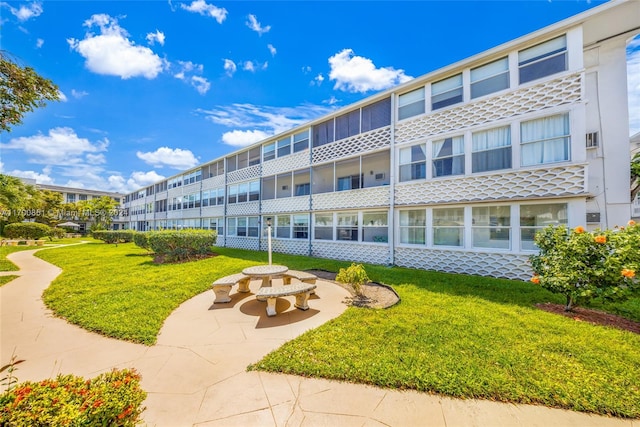 view of property's community with a yard and a patio