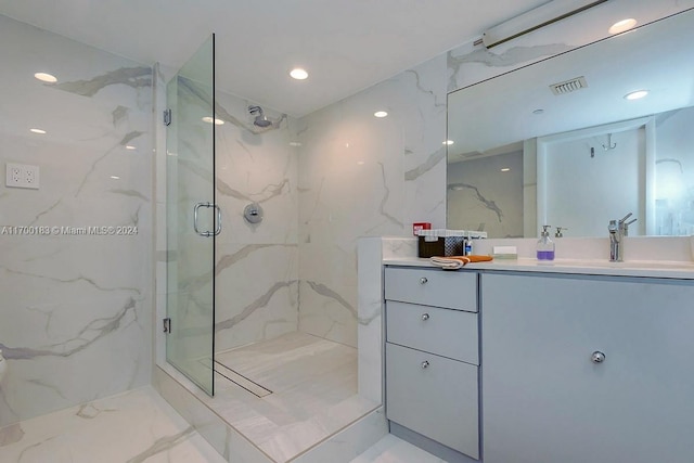 bathroom featuring vanity and a shower with shower door