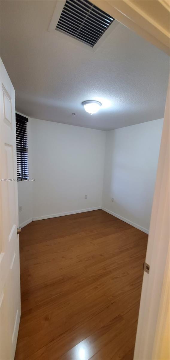 unfurnished room featuring wood-type flooring