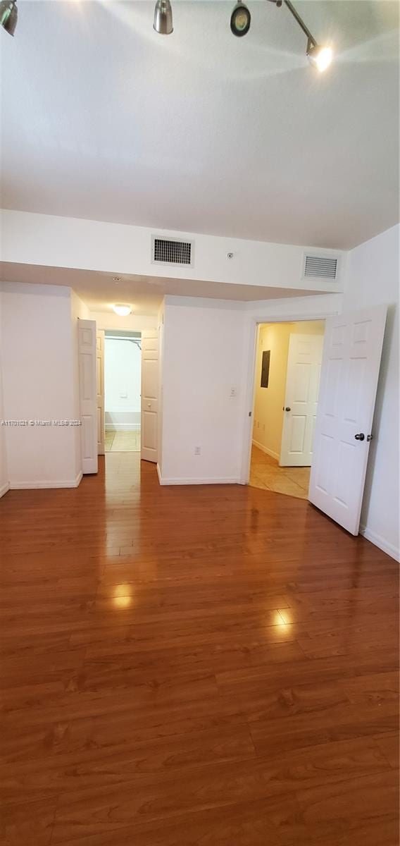 empty room with dark hardwood / wood-style flooring