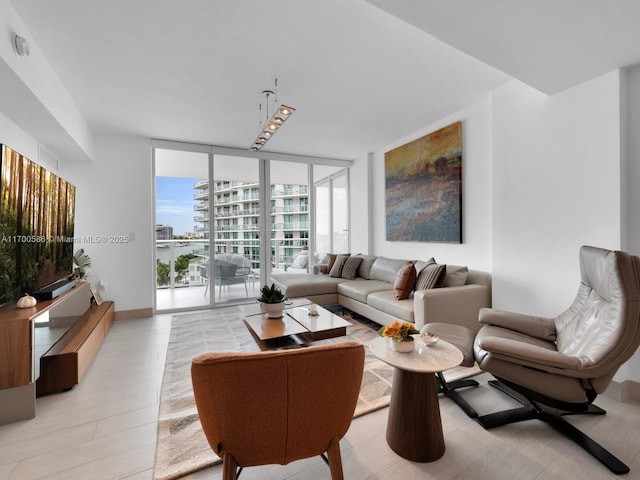 living room with light wood-style floors, floor to ceiling windows, and baseboards