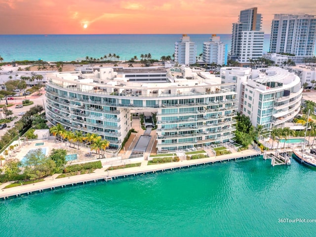 birds eye view of property with a water view and a city view