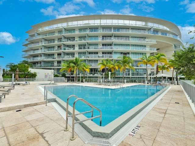 pool featuring a patio area and fence