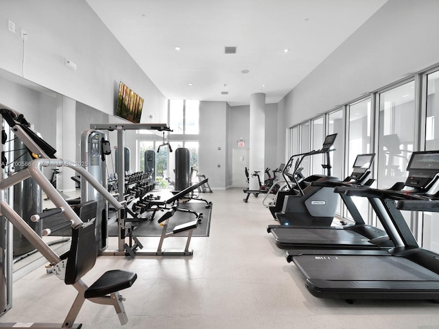 workout area featuring a high ceiling and visible vents