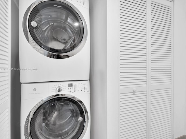 washroom with stacked washer / dryer and laundry area