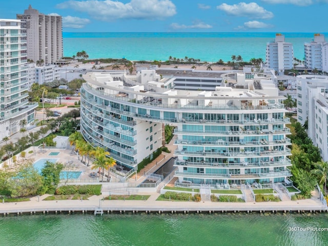 drone / aerial view featuring a view of city and a water view