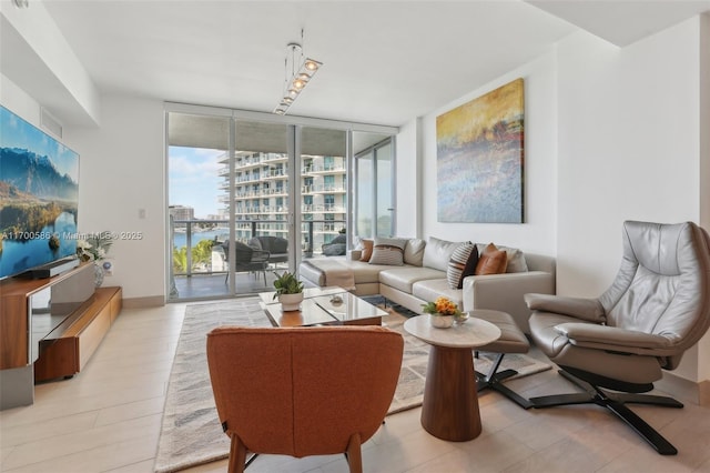 living area with baseboards and a wall of windows