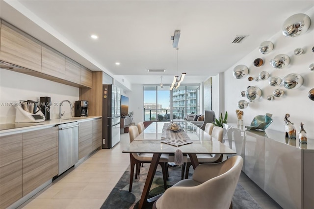 dining space with expansive windows, visible vents, and recessed lighting