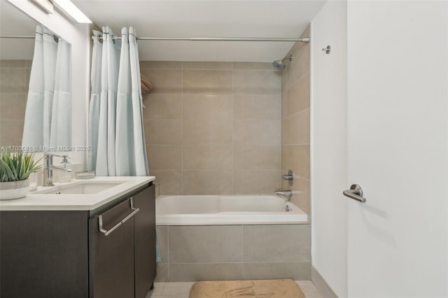 bathroom featuring tiled shower / bath combo and vanity