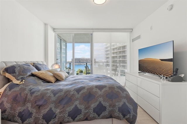 bedroom featuring floor to ceiling windows and access to exterior