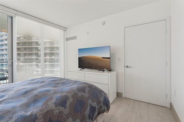 bedroom featuring visible vents and light wood finished floors