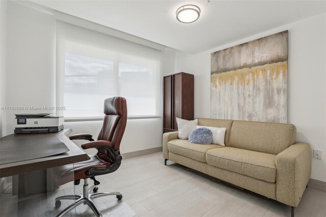 bedroom featuring multiple windows, light hardwood / wood-style flooring, and expansive windows