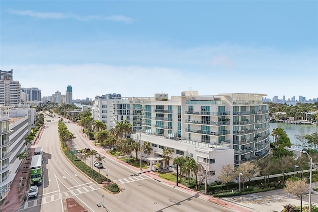 birds eye view of property featuring a city view and a water view