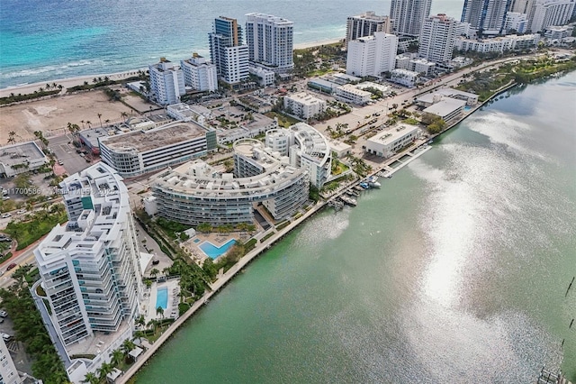 birds eye view of property featuring a water view, a view of city, and a view of the beach