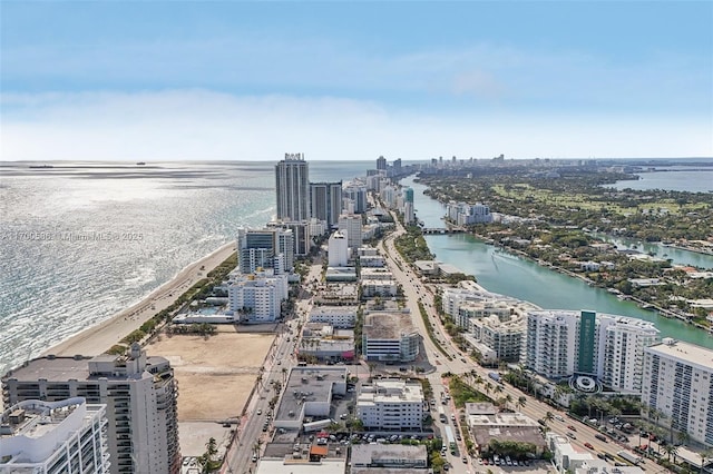 aerial view featuring a water view, a beach view, and a city view